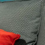 Divano modulare grigio con pouf rosso – dettaglio del tessuto – Confort Salotti